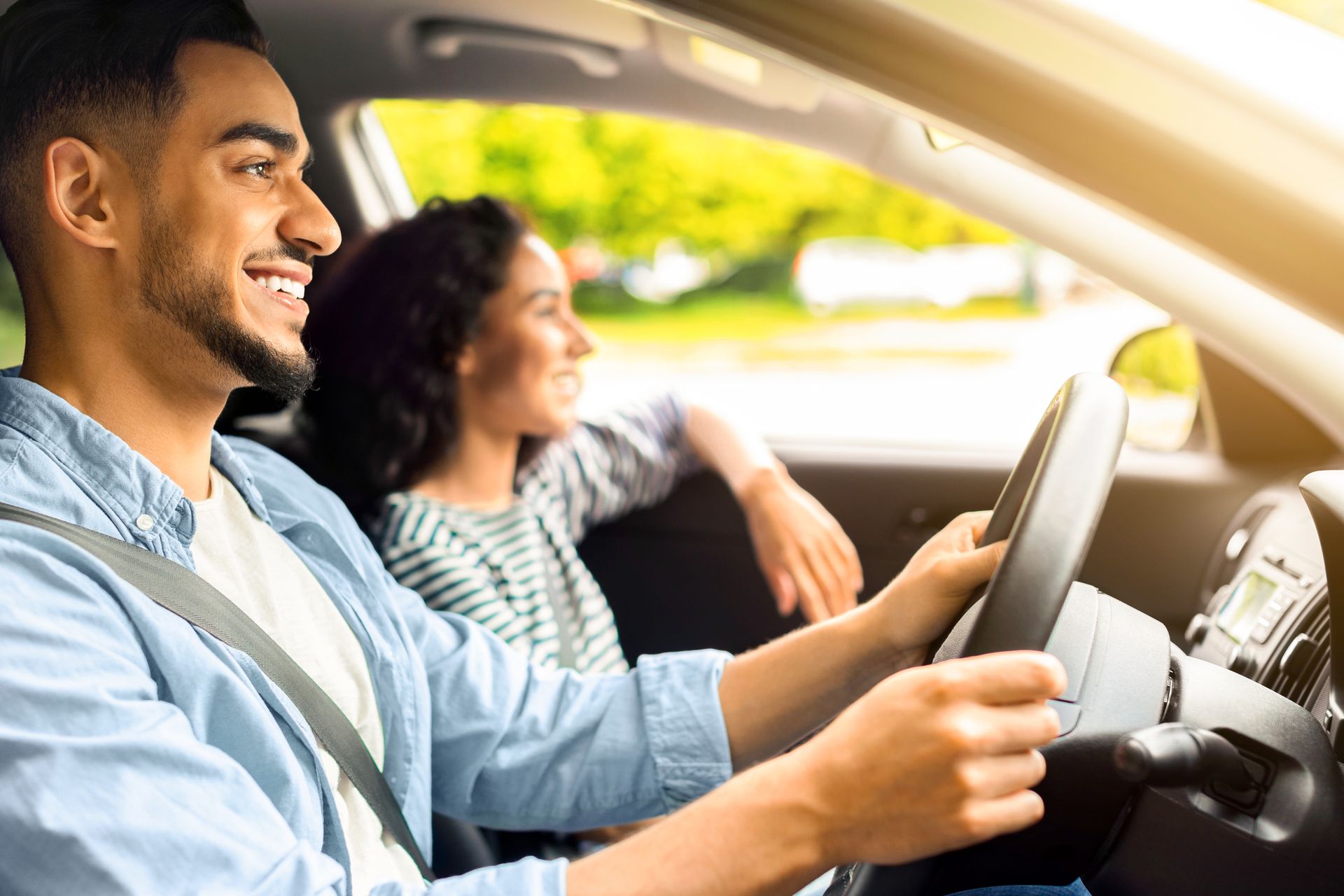 A woman is sitting at a table looking at her cell phone.