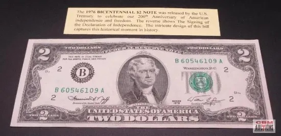 A two-dollar bill displayed with a note, commemorating the US Bicentennial.