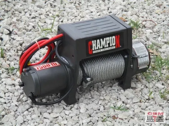 A champion winch is sitting on a pile of gravel.