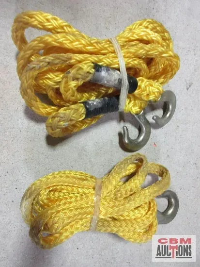 Yellow tow rope with metal hooks, coiled and bundled with a tie, on a surface.