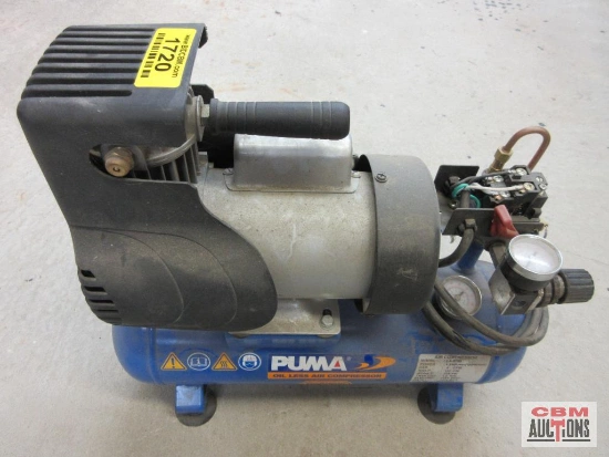 A puma air compressor is sitting on the floor