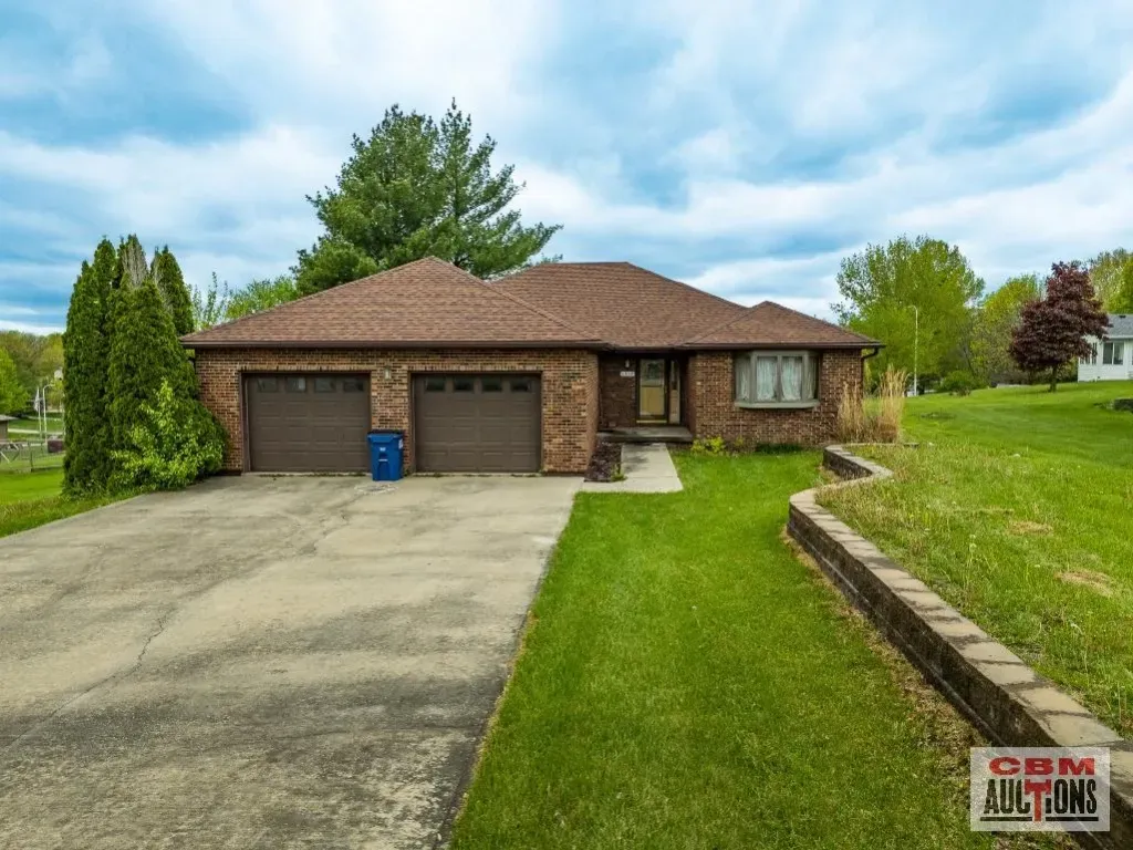 A brick house with two garage doors is for sale