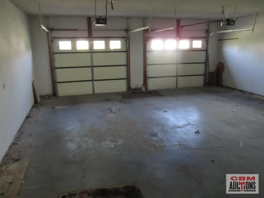 An empty garage with a sign that says com auctions