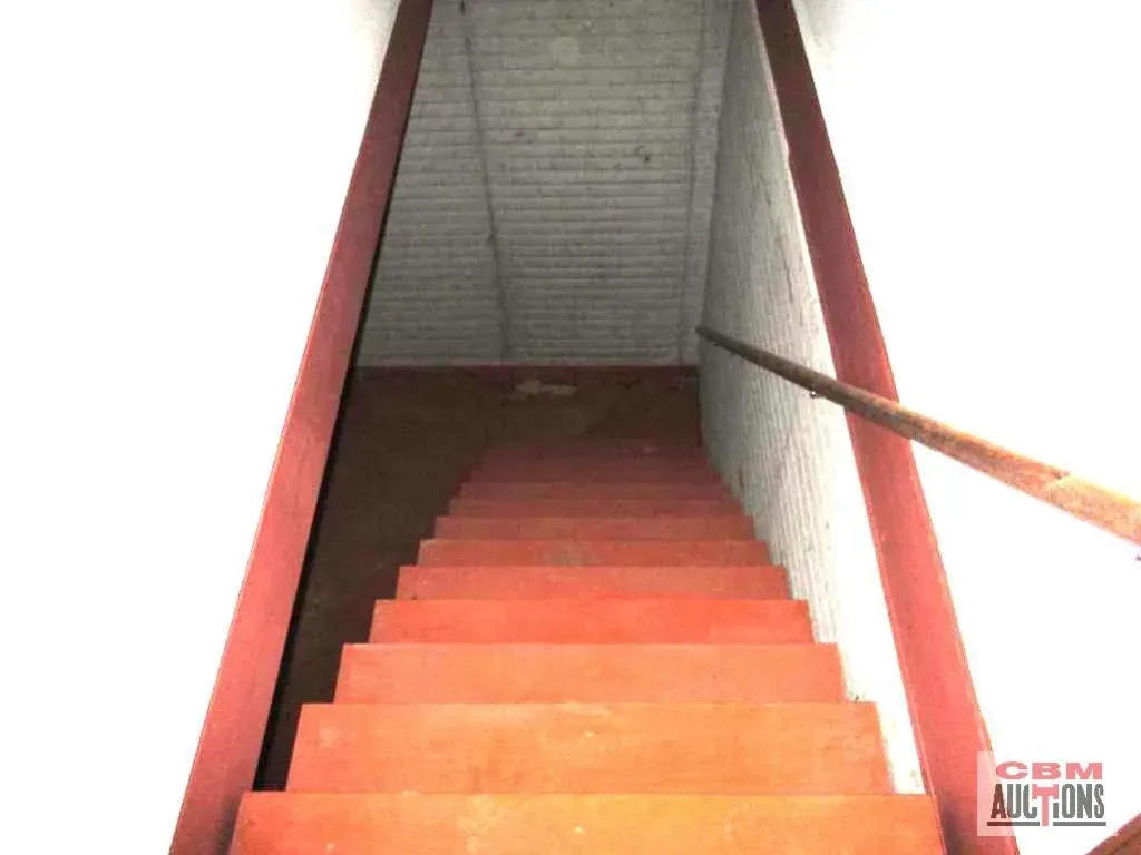 A set of red stairs leading up to a com auction