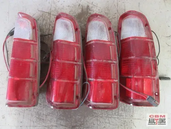 Four red and white vehicle tail lights.