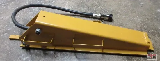 A yellow metal object with a hose attached to it