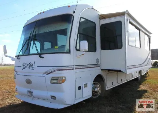 a white rv is being sold by cbm auctions