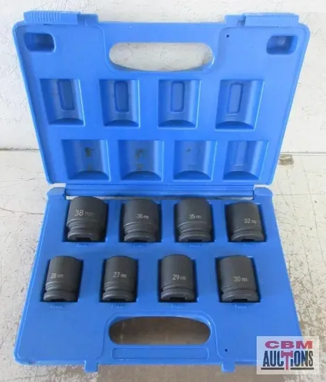 A green and black tractor is parked in a grassy field.