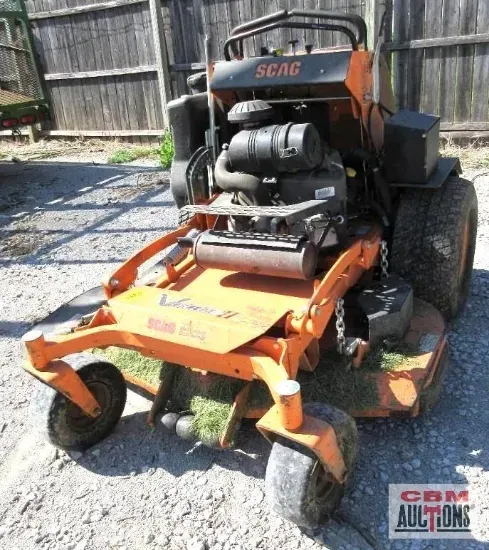 An orange lawn mower with the word scag on it