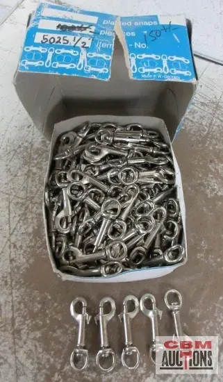 A box of keys sits on a table next to a box of chains