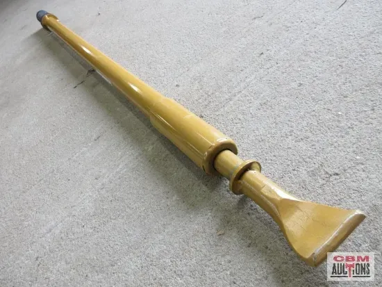 A long yellow object is sitting on a concrete surface ..