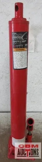 A red hydraulic jack is sitting on a table next to a sign that says adult home