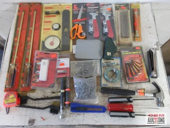Assorted tools: files, screwdrivers, scissors, a hammer, a tape measure, and more laid out on a white surface.
