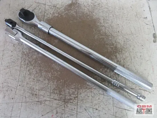 Two chrome wrenches on a worn, light-colored surface.
