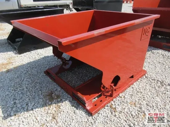 Red metal forklift hopper, angled, resting on gravel.