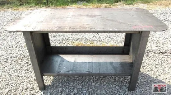 Metal work table with a shelf. Gray, outdoors.