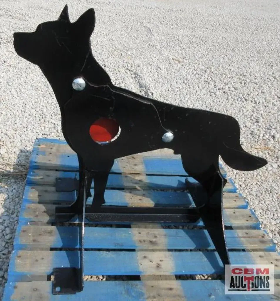 Black metal dog target on a blue-painted pallet, with a red target circle.
