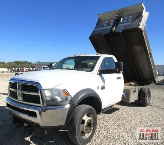 Hand axe with wooden handle and leather sheath on a textured surface.