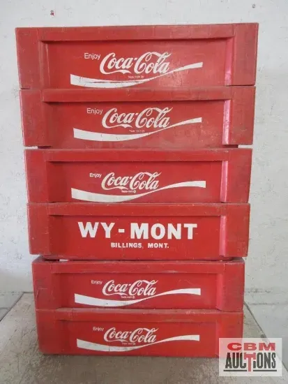 Stack of six red Coca-Cola crates, one with 