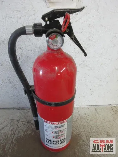 Red fire extinguisher with a black handle and pressure gauge.
