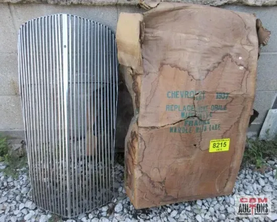 A chevrolet grill sits next to a cardboard box