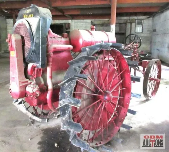 An old red tractor is for sale at cbm auctions