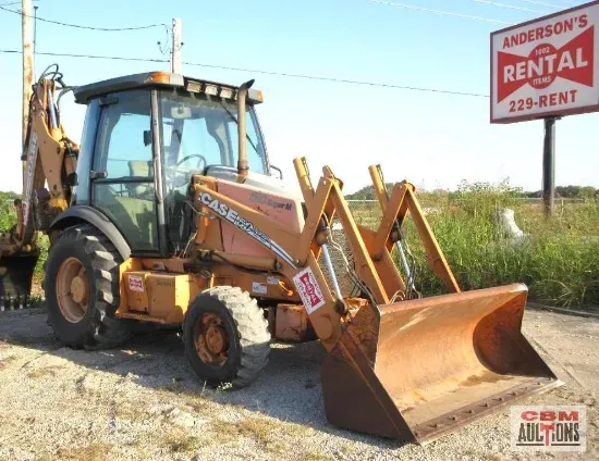 A tractor is parked in front of an anderson 's rental sign