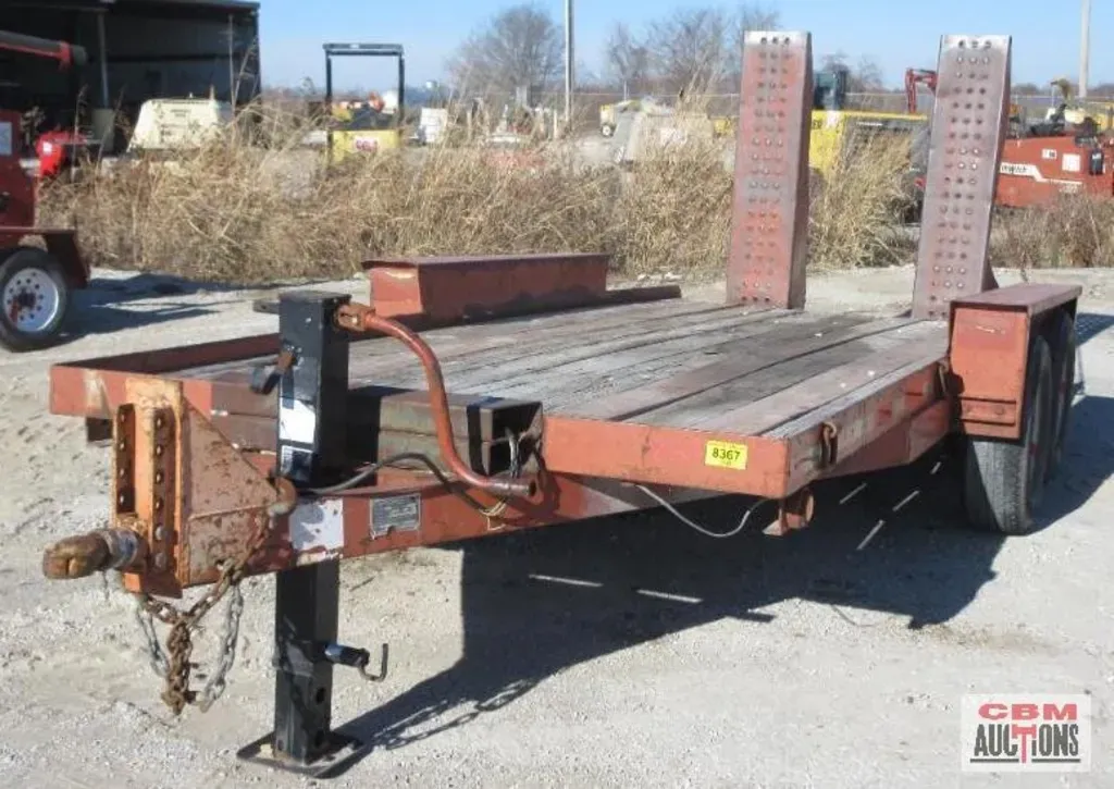 A trailer with a cbm auctioneering logo on the bottom