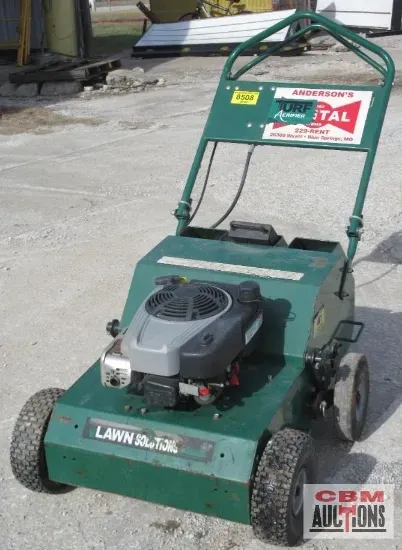 A red hose reel from cbm auctions sits on the floor