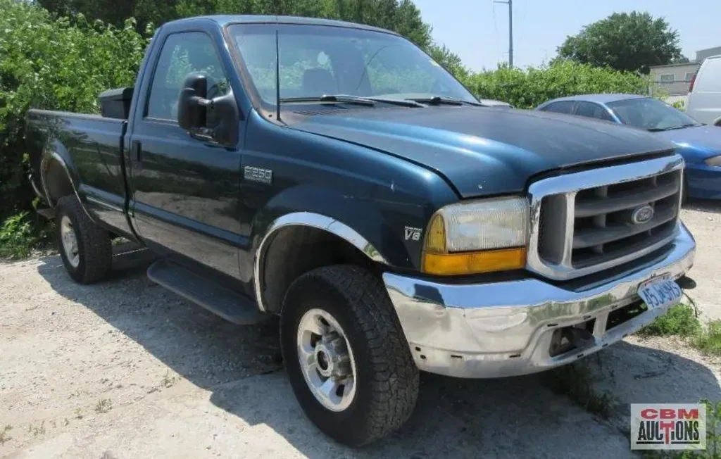A blue ford truck is parked in a parking lot