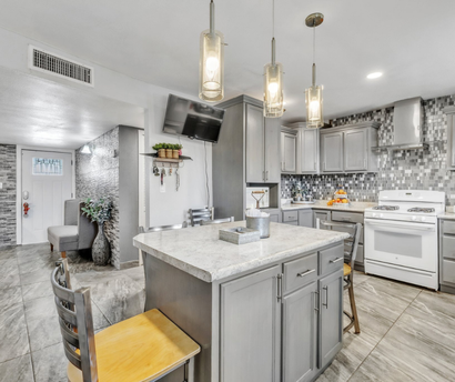A kitchen with a large island in the middle of it.