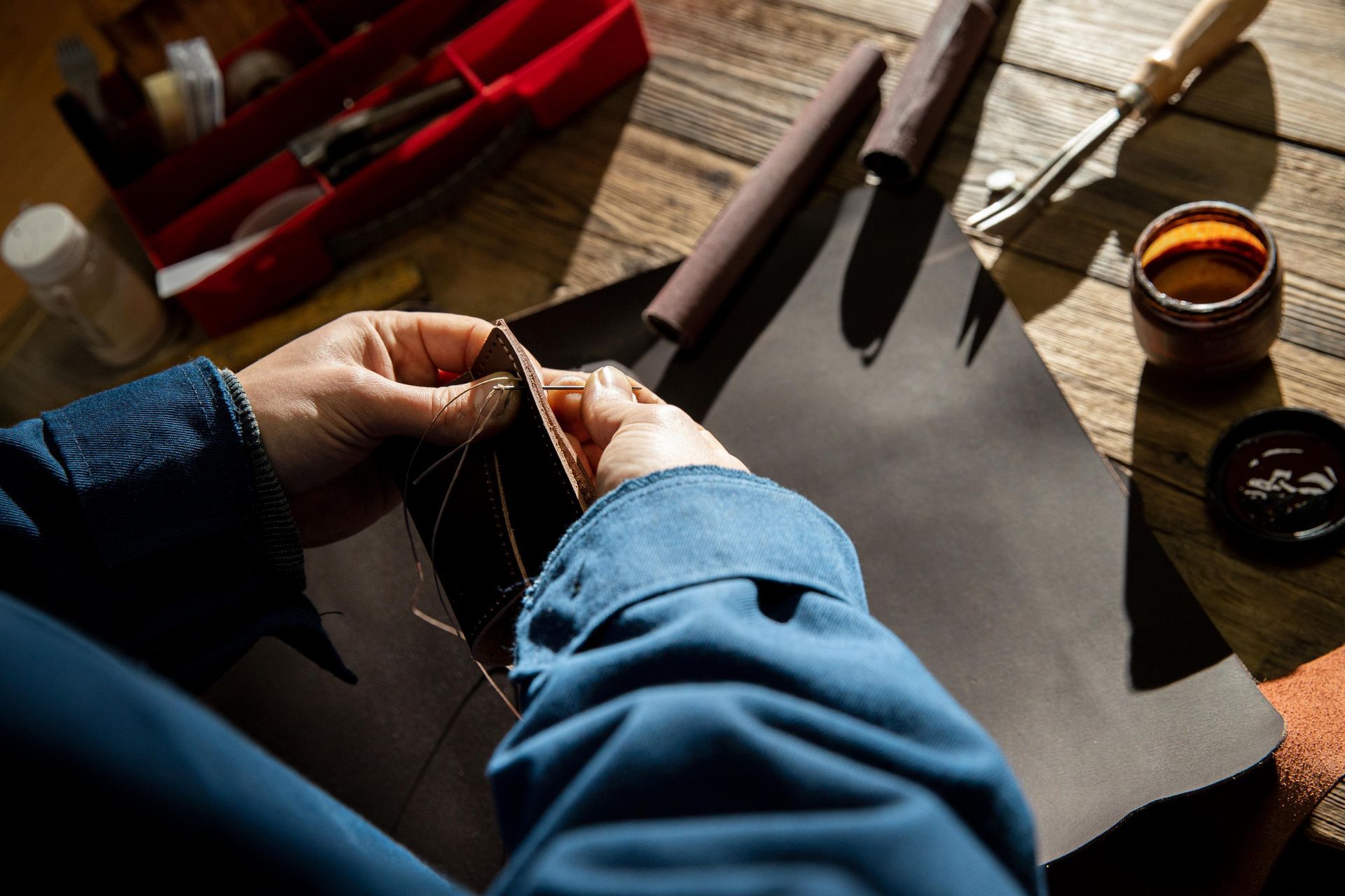 A close up of a brown leather jacket with a zipper.