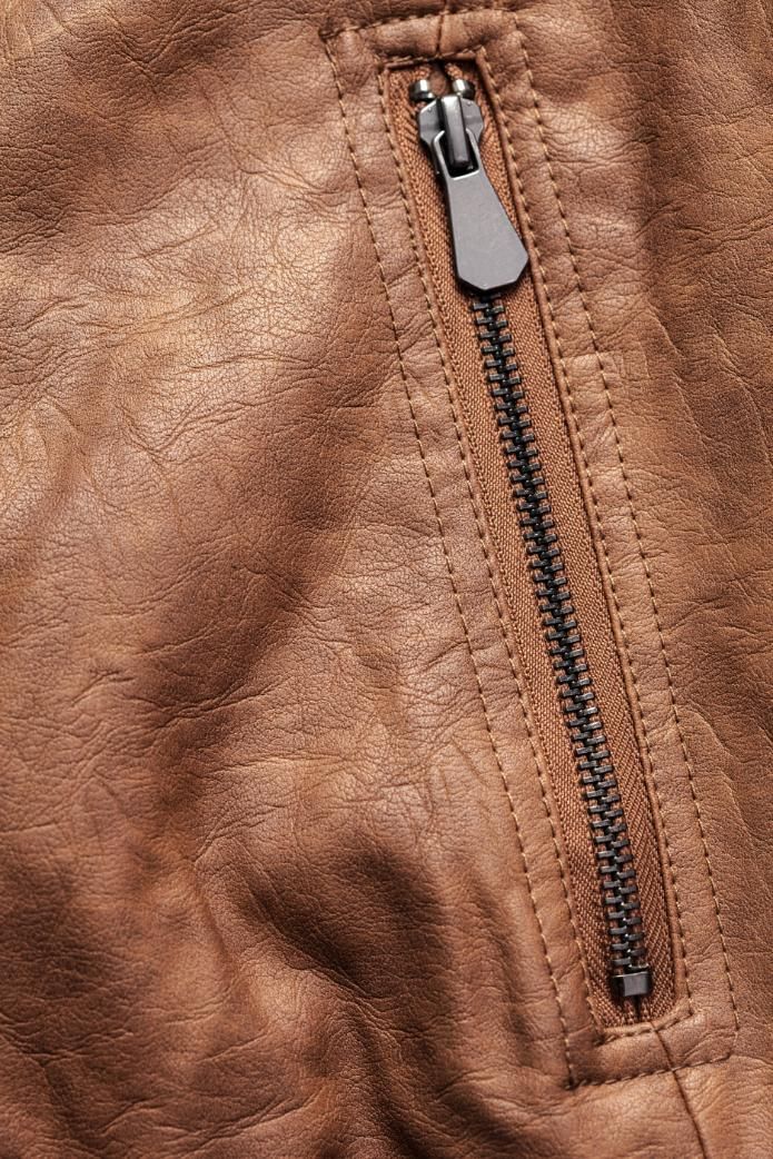 A close up of a brown leather jacket with a zipper.