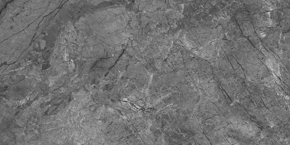 Gray stone surface with cracks and variations in texture.