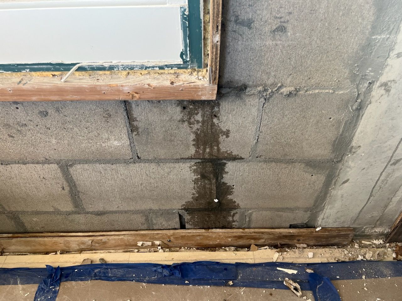 Person in workwear with a testing device on a countertop near a sink