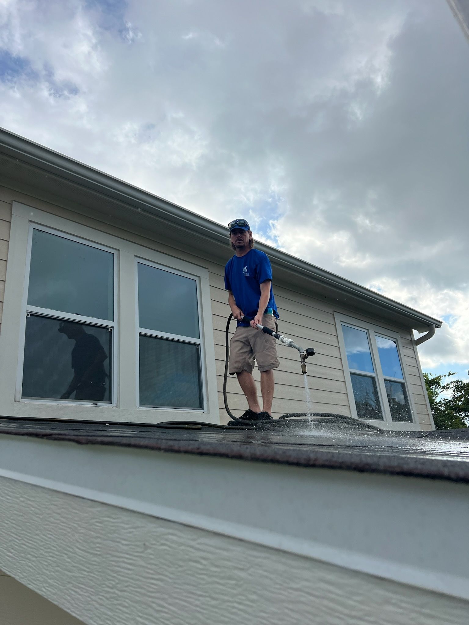Person inspecting plumbing with a borescope inside a cabinet