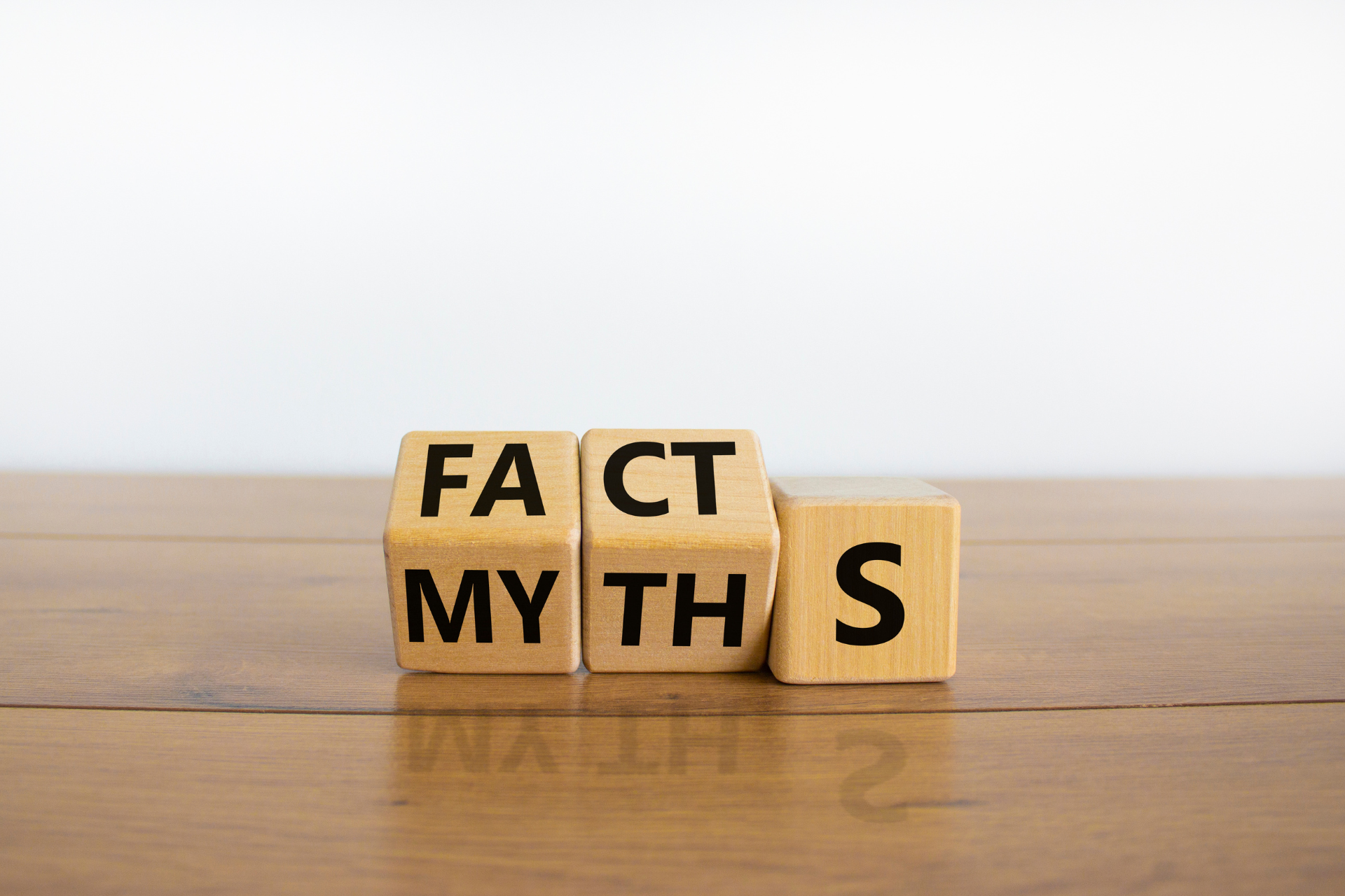 the word myth is written on wooden blocks on a wooden table .