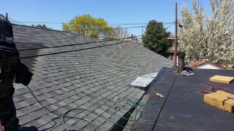 Worker Installing New Roof Tiles — York, PA — Dallastown Roofing & Contracting