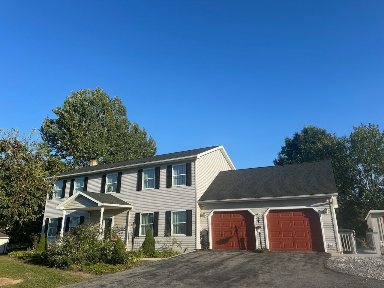 A house with a garage and a driveway in front of it