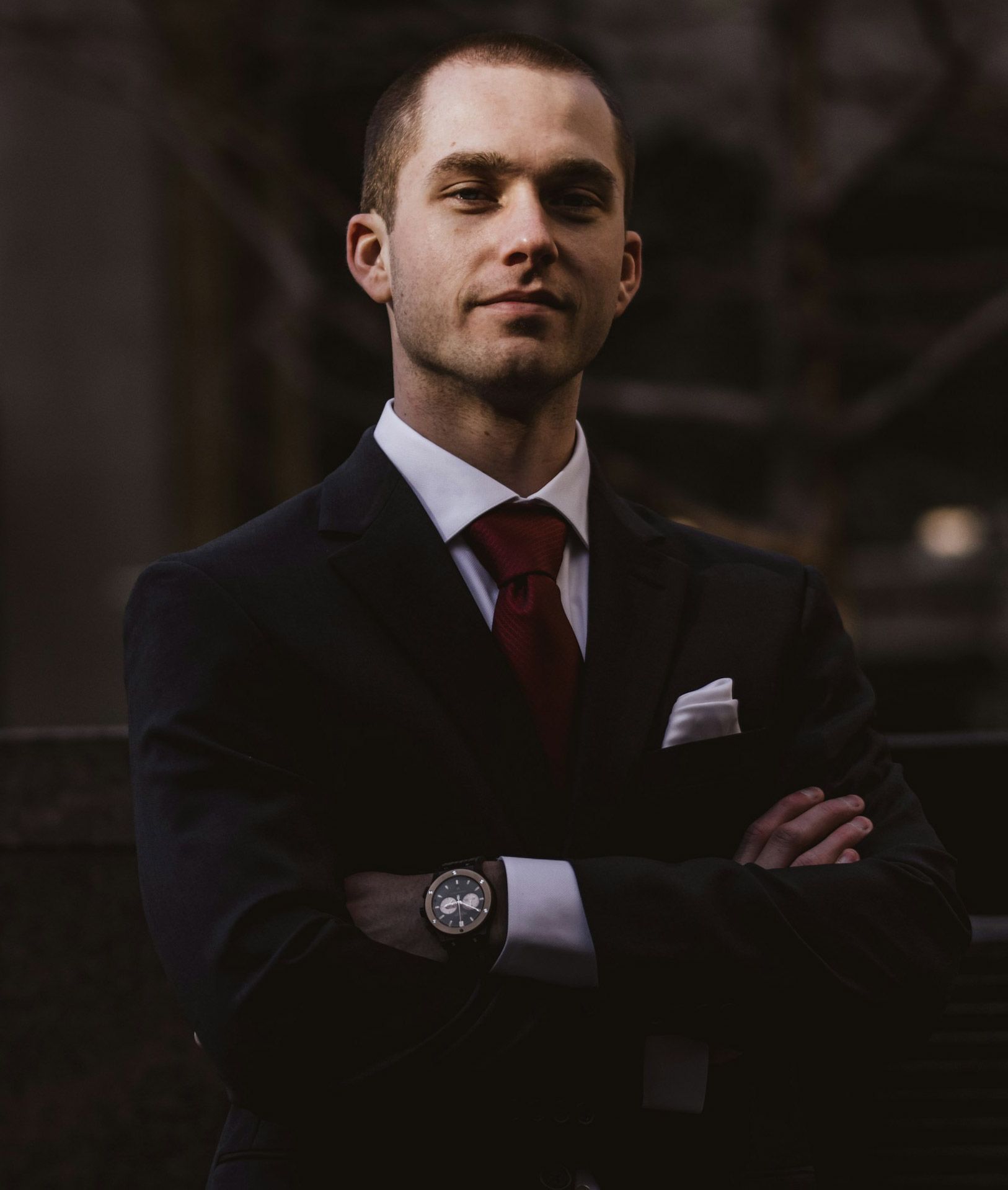 Two smiling men walking together outdoors, arm in arm. Sunny day.