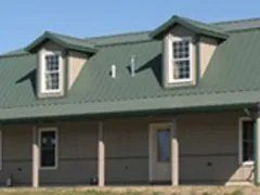 A house with a green roof and a porch.