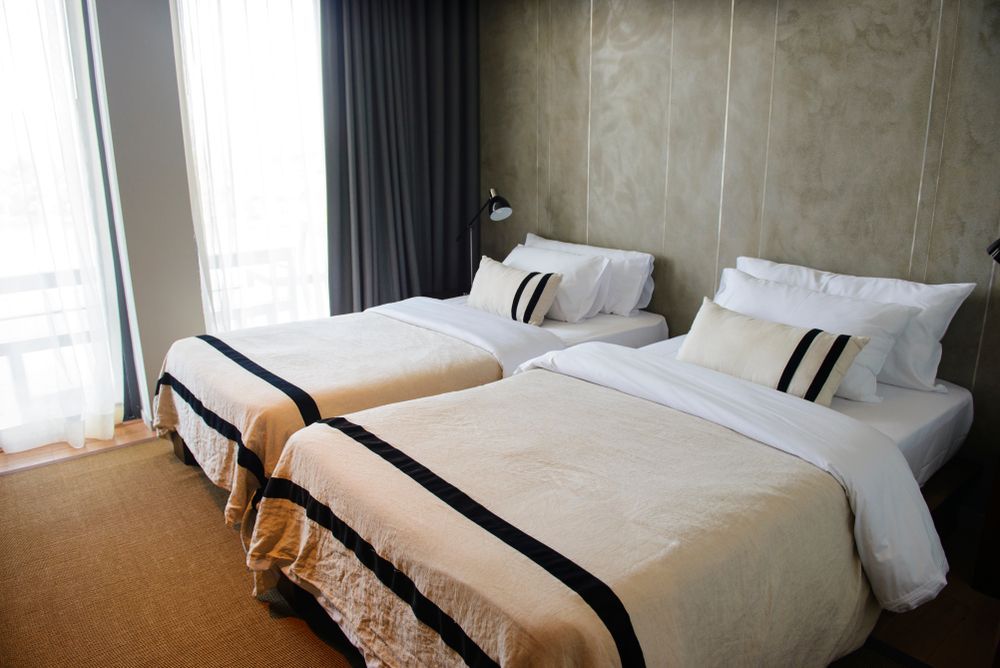 Two Neatly Made Twin Beds in a Bright Hotel Room — Original North Australian in Bowen, QLD