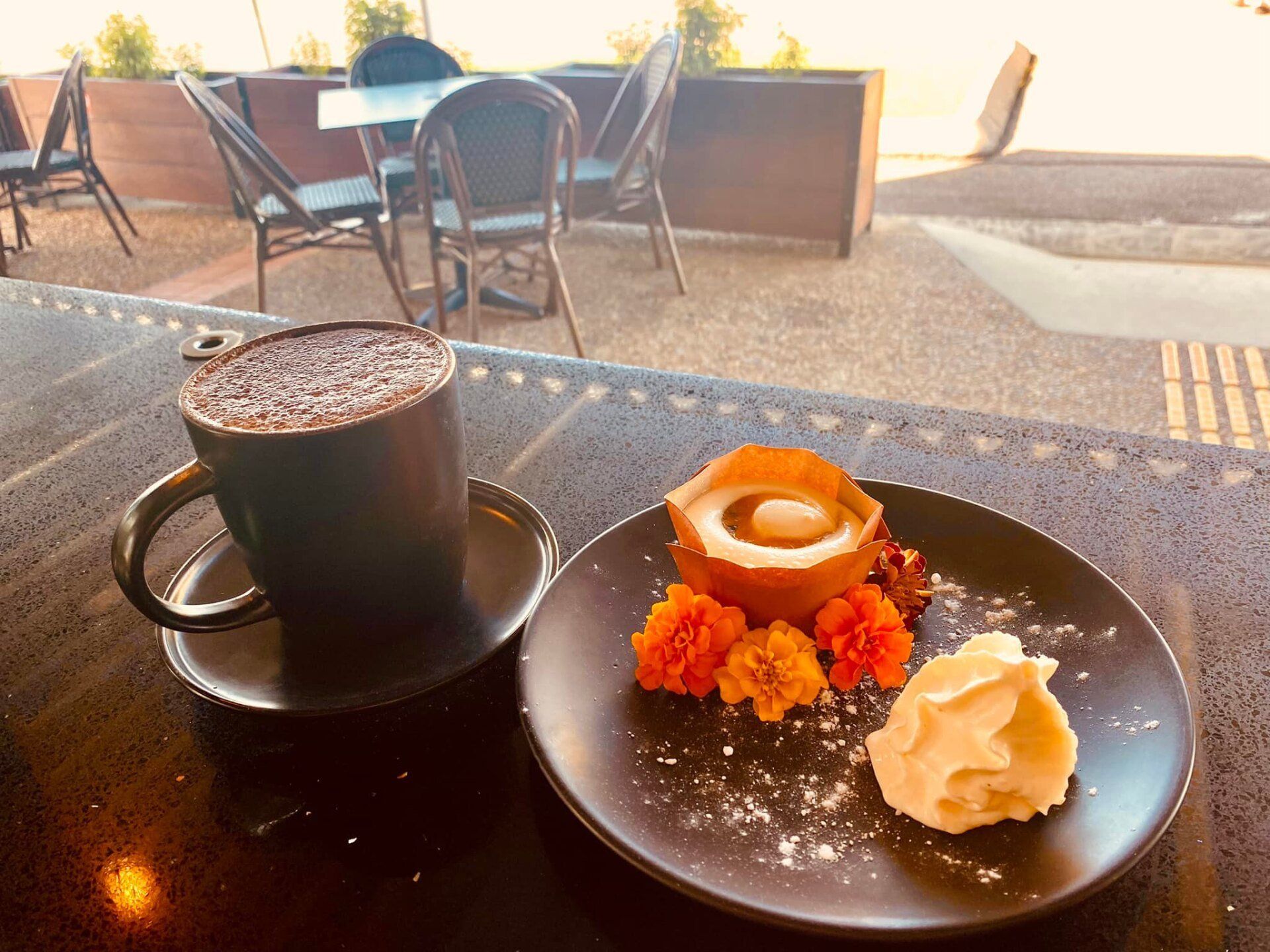 A Cup Of Coffee And A Plate Of Food On A Table — Original North Australian in Bowen, QLD