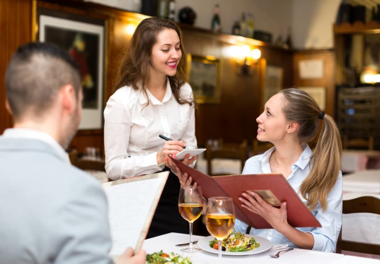 A Woman Is Taking A Order From A Man And A Woman — Original North Australian in Bowen, QLD
