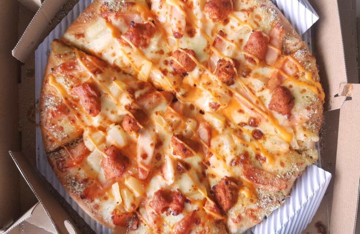 A Pizza With A Lot Of Toppings Is In A Box — Original North Australian in Bowen, QLD