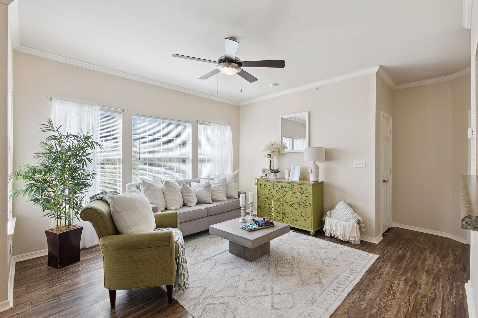 Living room with gray sofa, green armchair, and a lime green cabinet.
