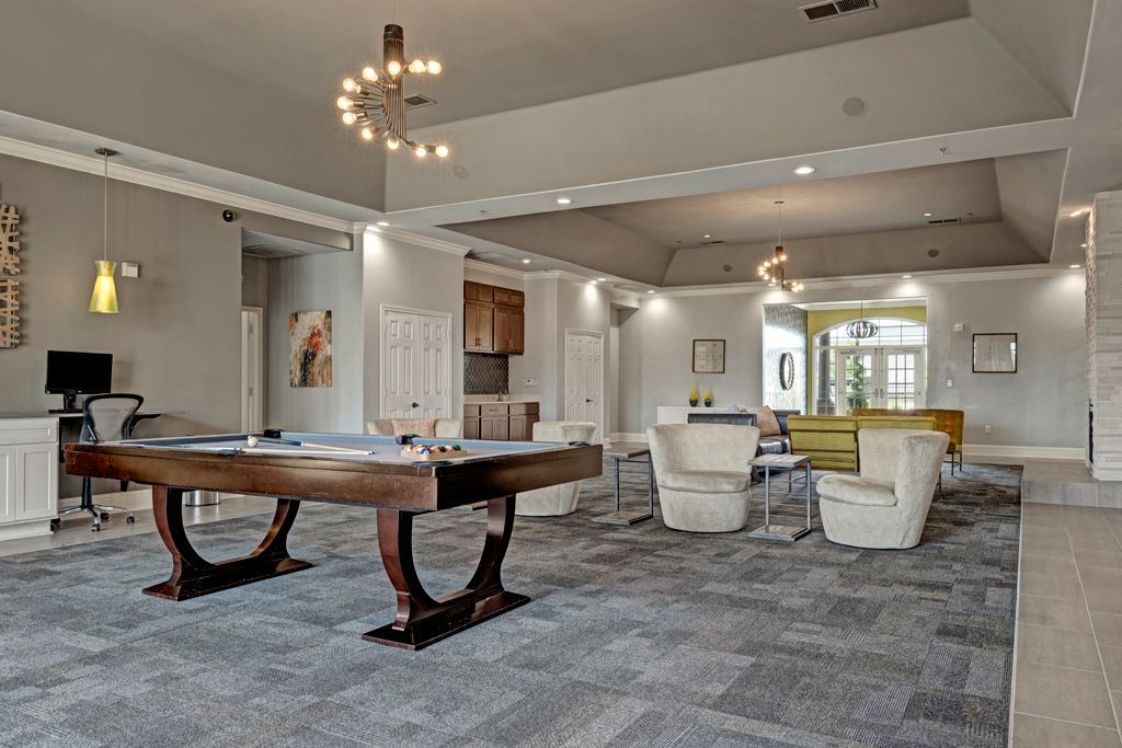 There is a pool table in the middle of the room.