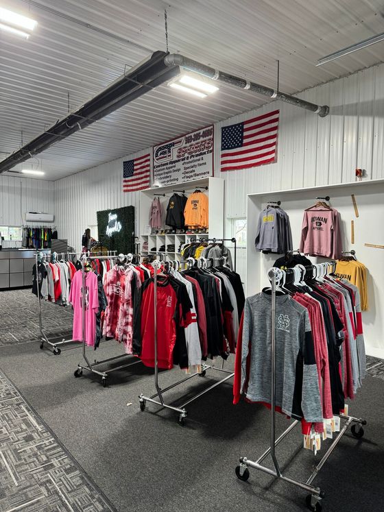 A store filled with lots of clothes hanging on racks.