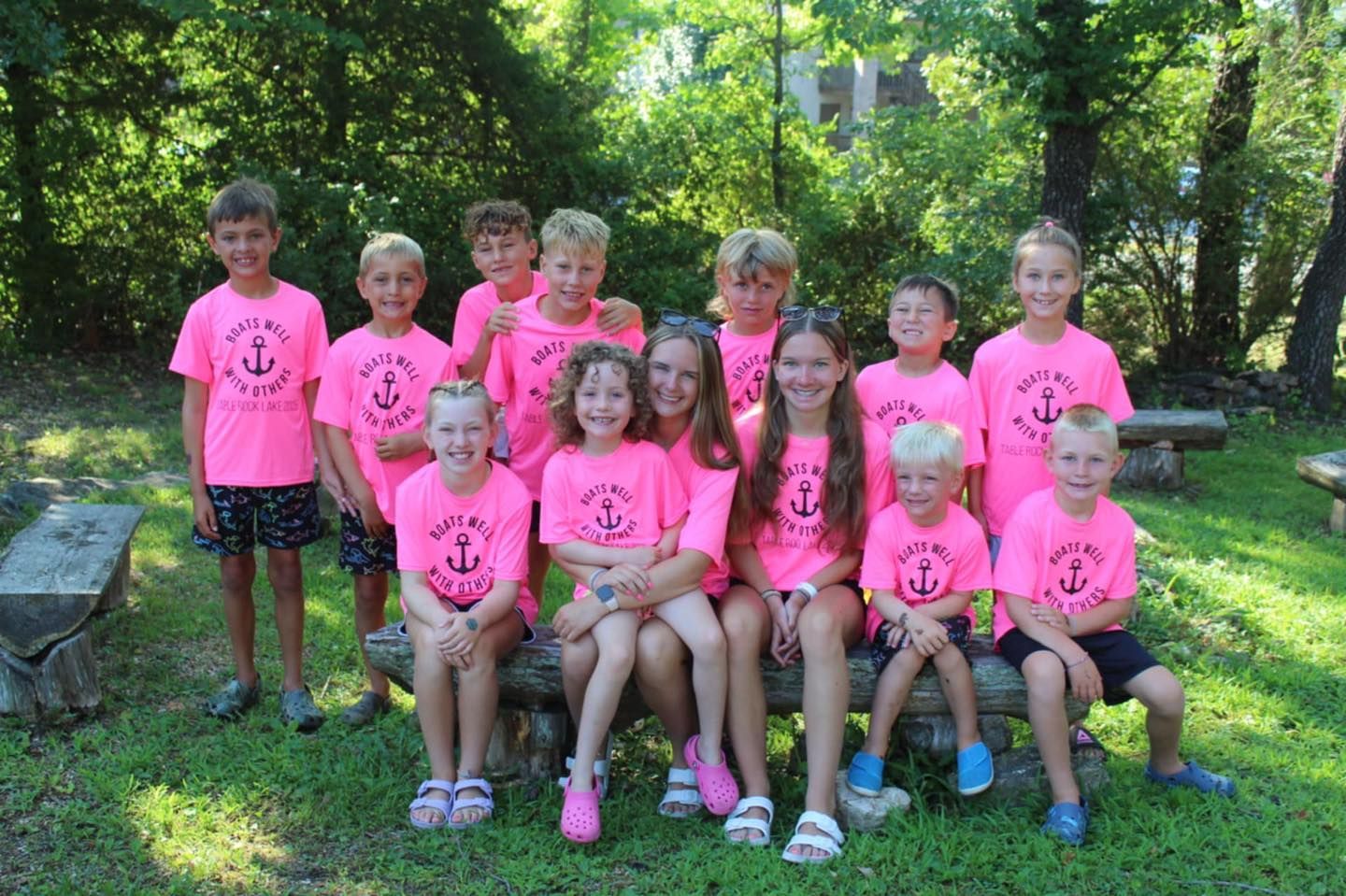 A person is holding a black t-shirt with the word lancers on it.