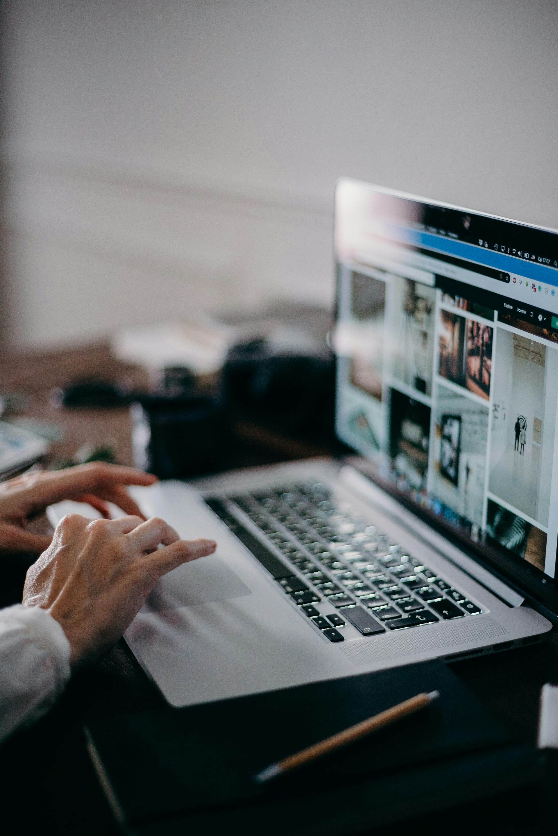 A person is typing on a laptop computer.